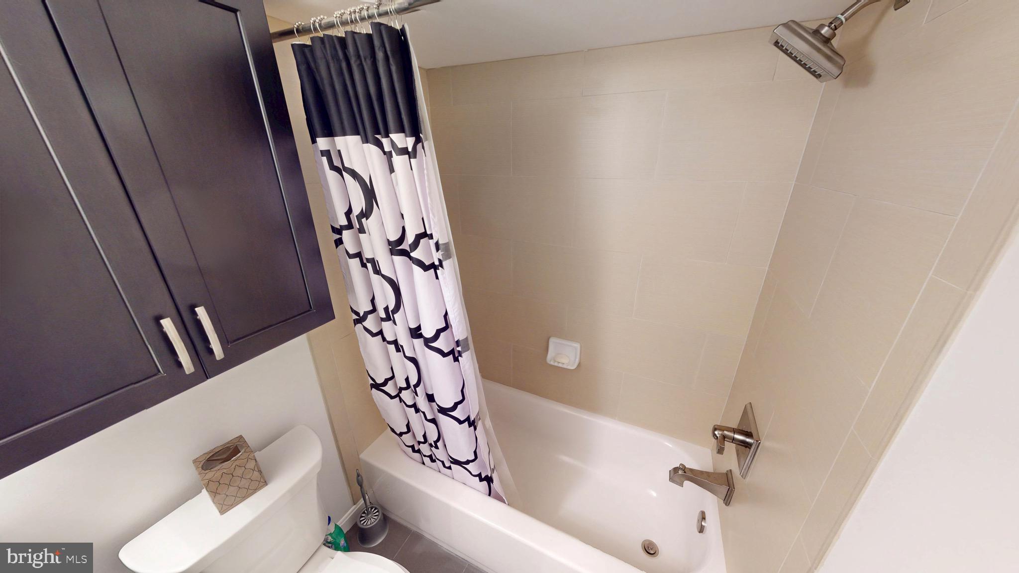 306 South Exeter Street Baltimore, MD 21202 - Photo 33 of 35 a bathroom with a bathtub and shower