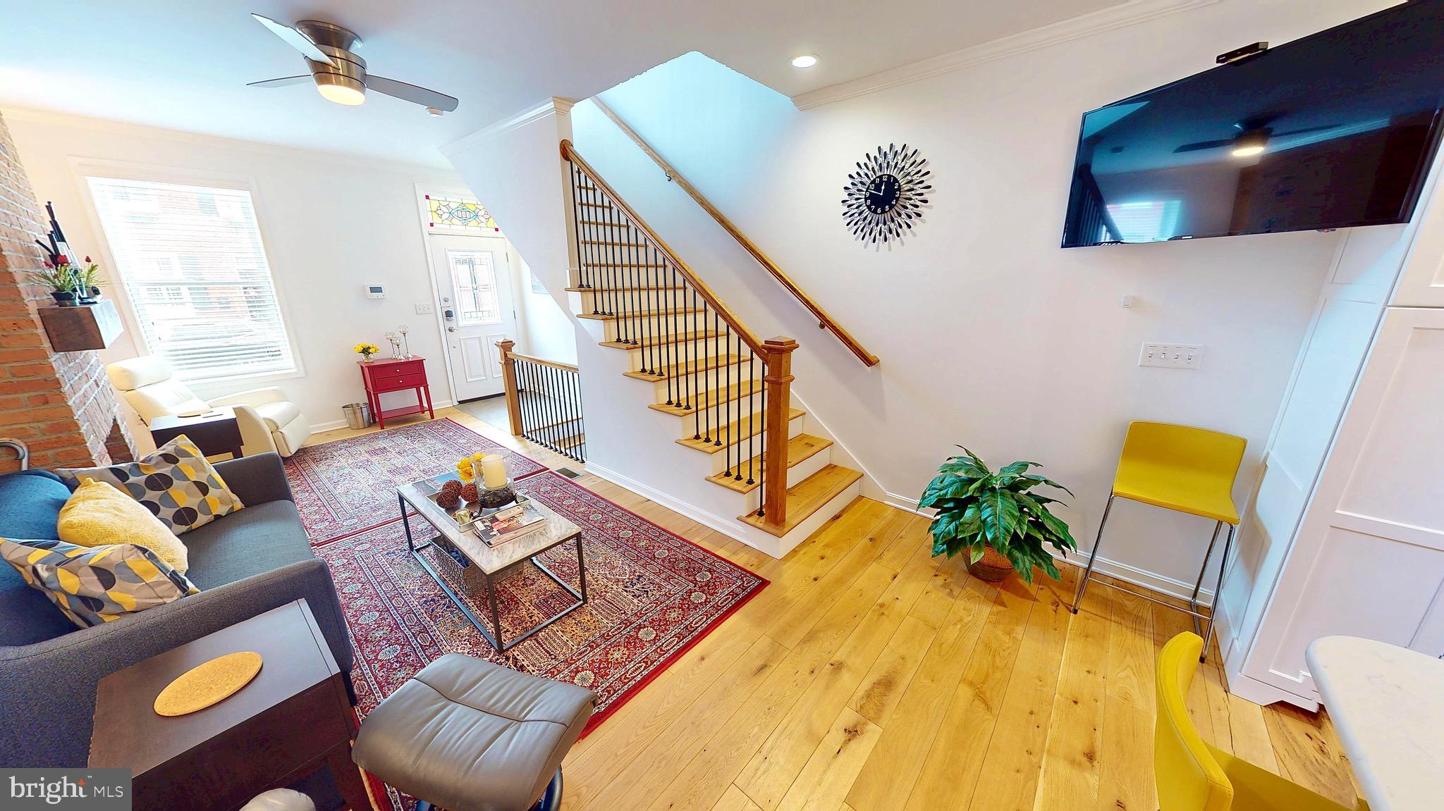 306 South Exeter Street Baltimore, MD 21202 - Photo 5 of 35 a living room with furniture and wooden floor