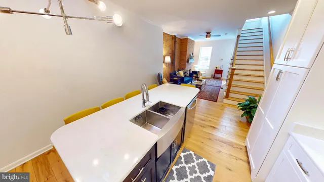 a view of living room with furniture and wooden floor
