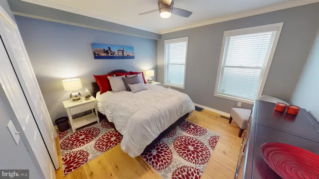 a bedroom with a bed and a lamp on dresser