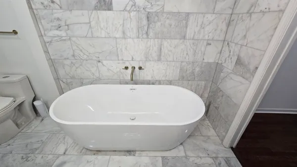 a white bath tub sitting in a bathroom