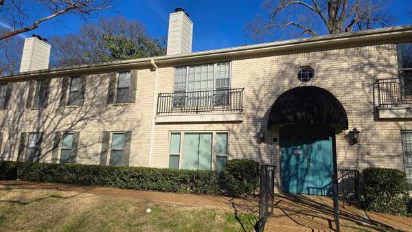 a front view of a house with large windows