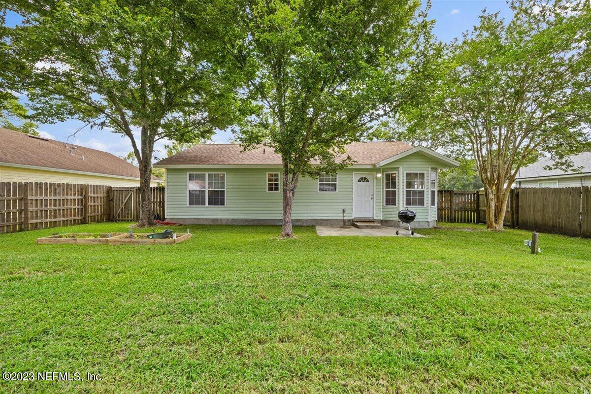 725 Alexander Street St. Augustine, FL 32084 - Photo 13 of 13 a front view of a house with a garden