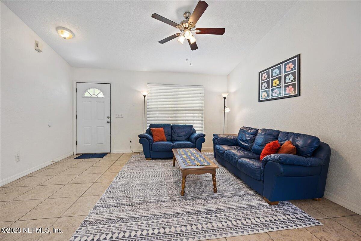 725 Alexander Street St. Augustine, FL 32084 - Photo 5 of 13 a living room with furniture and a rug