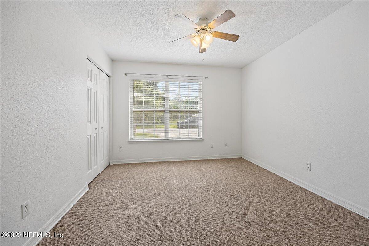 725 Alexander Street St. Augustine, FL 32084 - Photo 8 of 13 an empty room with windows and fan