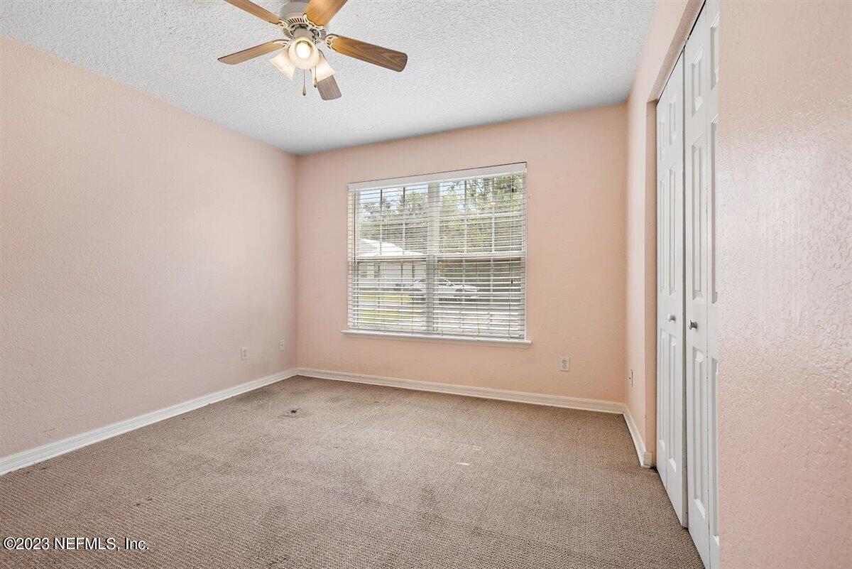 725 Alexander Street St. Augustine, FL 32084 - Photo 9 of 13 an empty room with a window and a fan