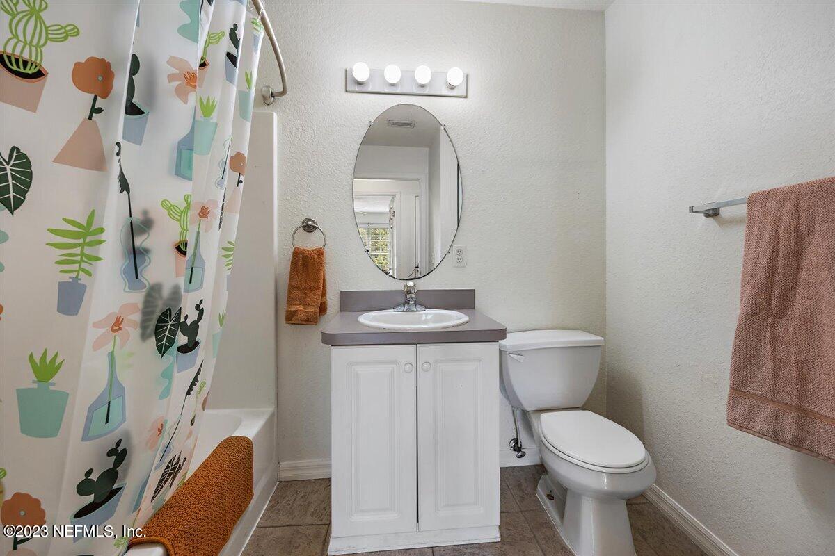 725 Alexander Street St. Augustine, FL 32084 - Photo 10 of 13 a bathroom with a toilet a sink and a mirror