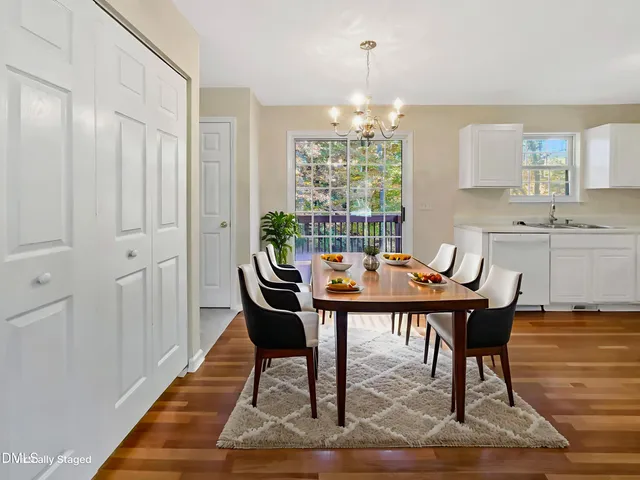 a view of a dining room with furniture window and wooden floor