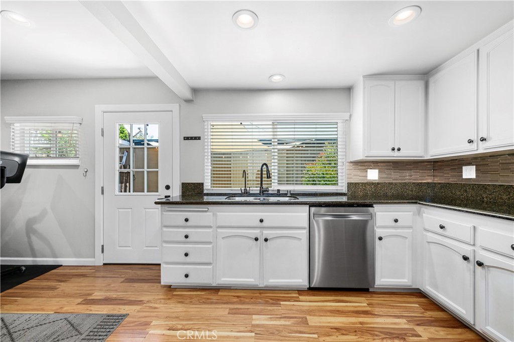 4237 Larwin Avenue Cypress, CA 90630 - Photo 15 of 48 a kitchen with granite countertop a sink window and cabinets