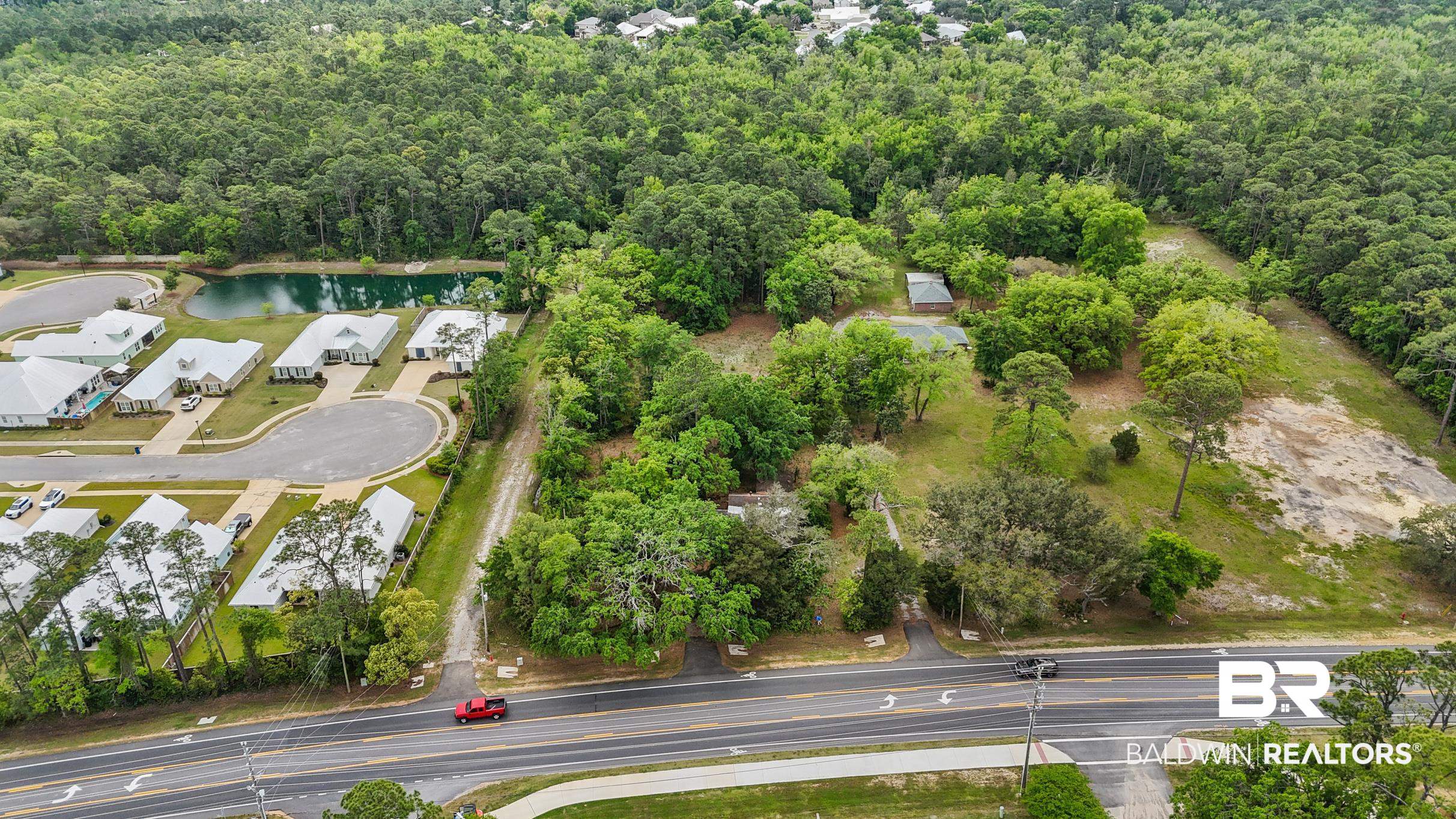 26486 Canal Road Orange Beach, AL 36561 - Photo 3 of 9 Aerial view featuring a view of trees and a water view