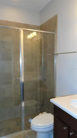 a bathroom with a shower a toilet and sink