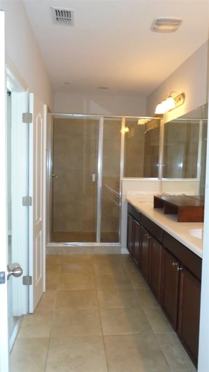 466 Windmill Palm Circle Altamonte Springs, FL 32701 - Photo 16 of 23 a bathroom with a double vanity sink mirror and shower