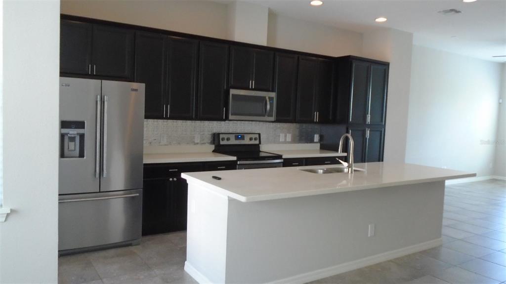 466 Windmill Palm Circle Altamonte Springs, FL 32701 - Photo 3 of 23 a kitchen with appliances a sink and a refrigerator