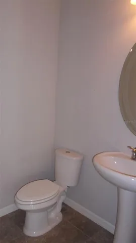 a white toilet sitting next to a bathroom sink