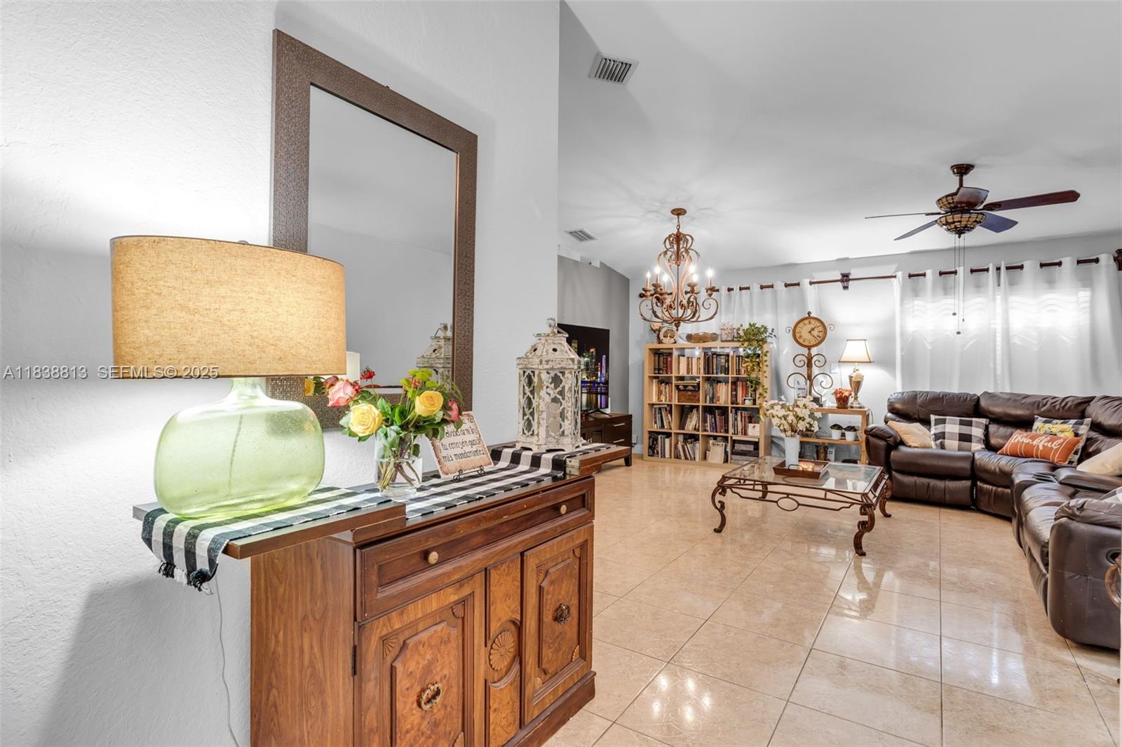 25237 Southwest 133rd Place Homestead, FL 33032 - Photo 11 of 39 a living room with furniture and chandelier