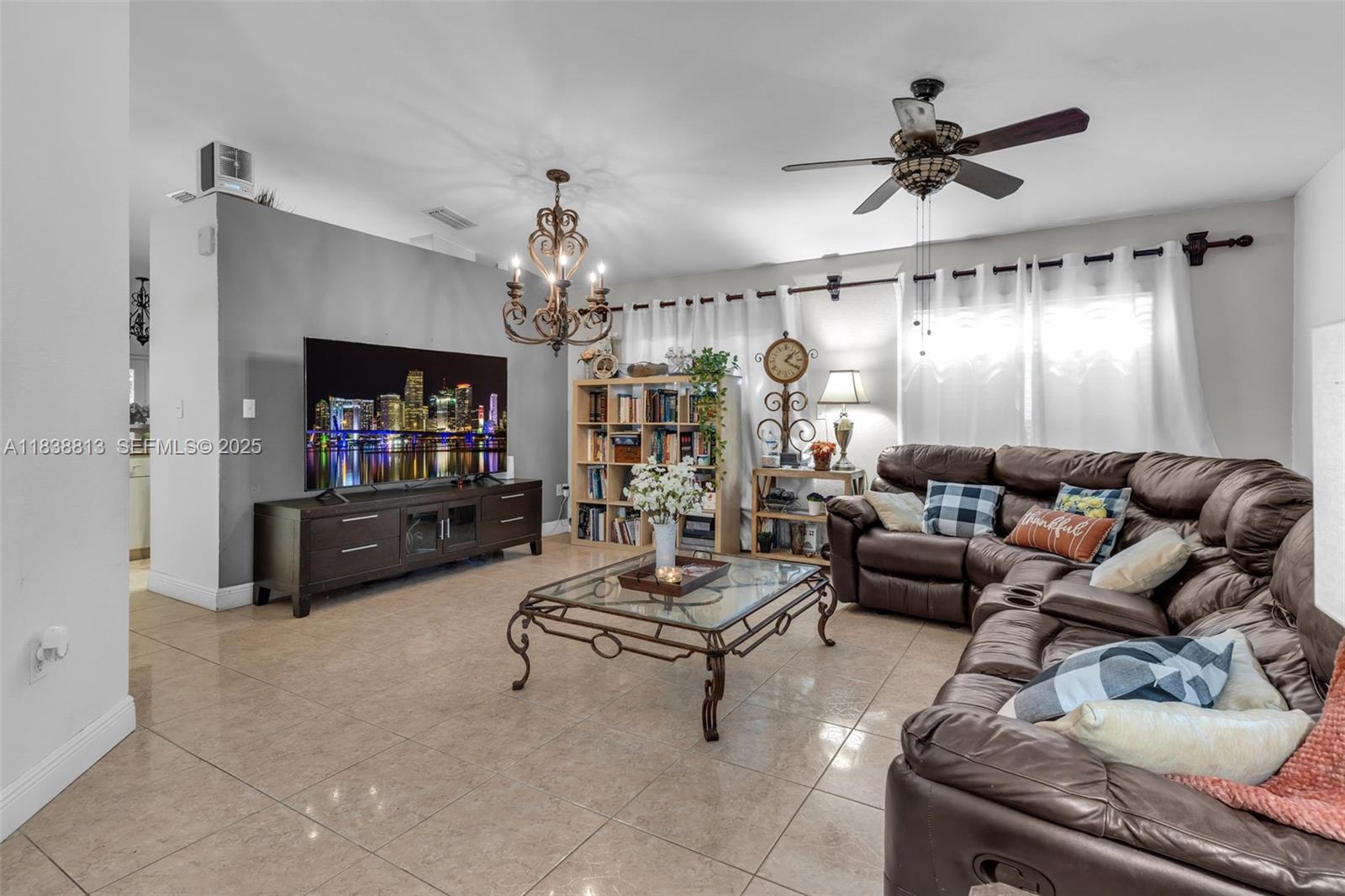 25237 Southwest 133rd Place Homestead, FL 33032 - Photo 12 of 39 a living room with furniture and a flat screen tv