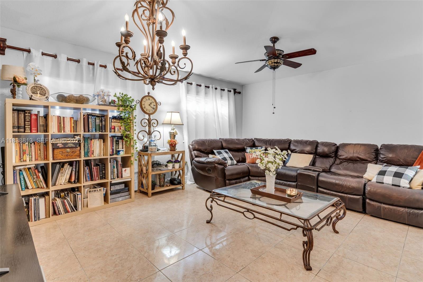 25237 Southwest 133rd Place Homestead, FL 33032 - Photo 14 of 39 a living room with lots of furniture and a book shelf