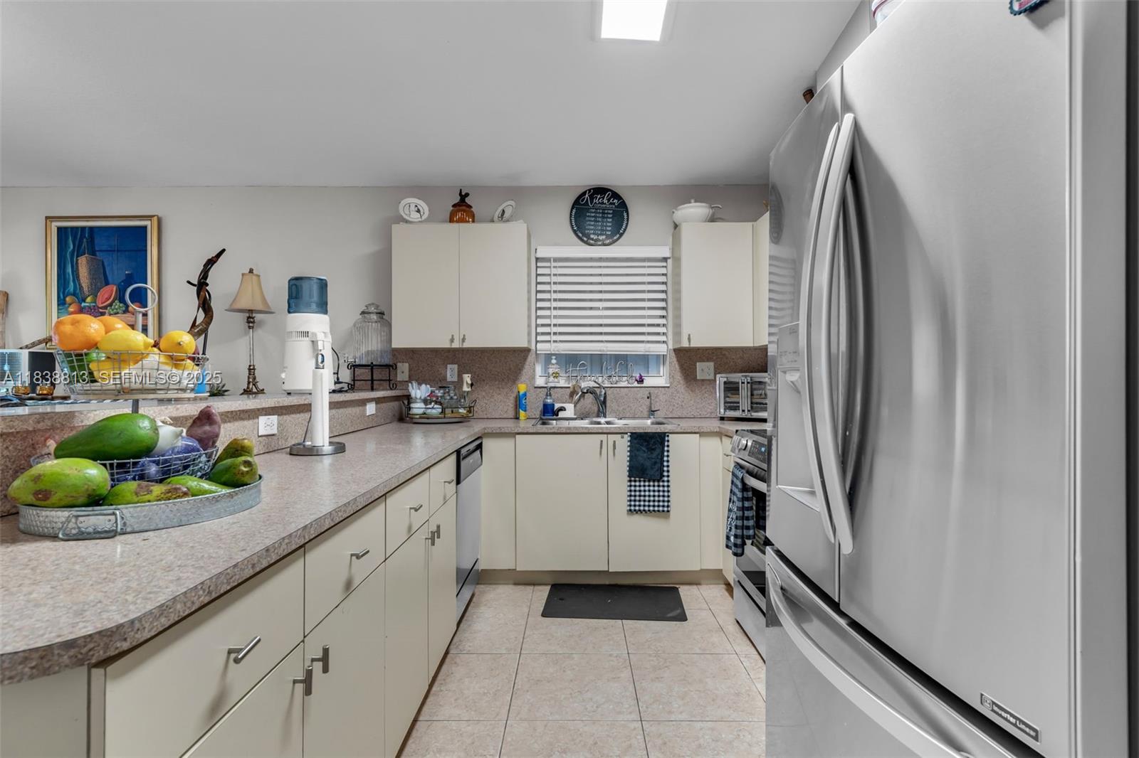 25237 Southwest 133rd Place Homestead, FL 33032 - Photo 19 of 39 a kitchen with a sink stainless steel appliances and white cabinets