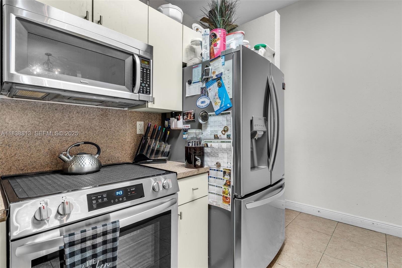 25237 Southwest 133rd Place Homestead, FL 33032 - Photo 20 of 39 a kitchen with a stove and a refrigerator