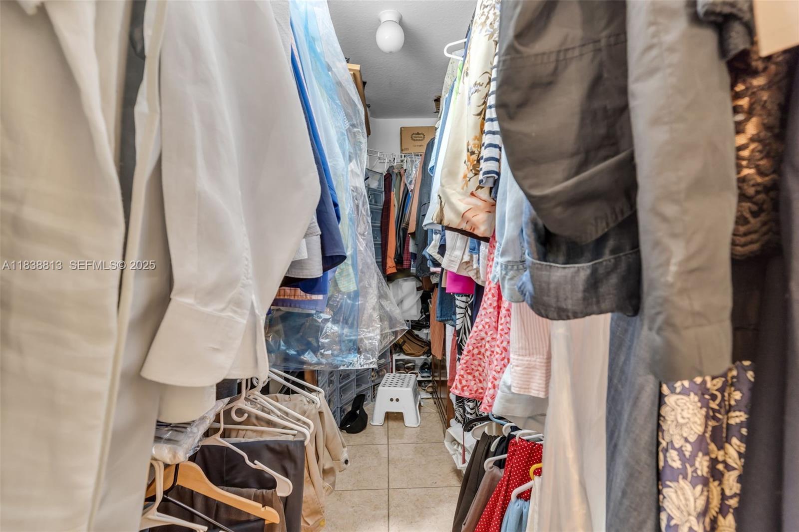 25237 Southwest 133rd Place Homestead, FL 33032 - Photo 23 of 39 a view of walk in closet with clothes and shoes