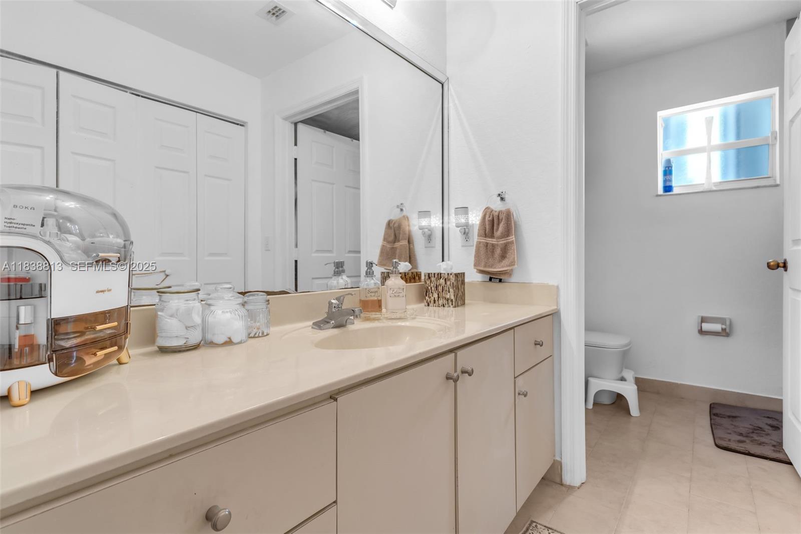 25237 Southwest 133rd Place Homestead, FL 33032 - Photo 26 of 39 a bathroom with a sink and a mirror
