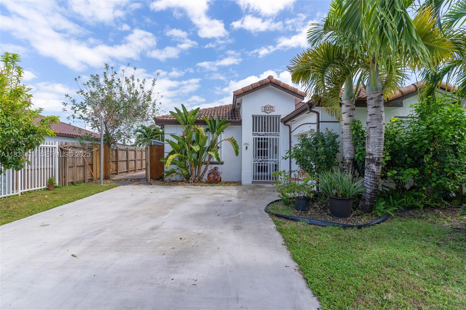 25237 Southwest 133rd Place Homestead, FL 33032 - Photo 3 of 39 a front view of a house with a garden