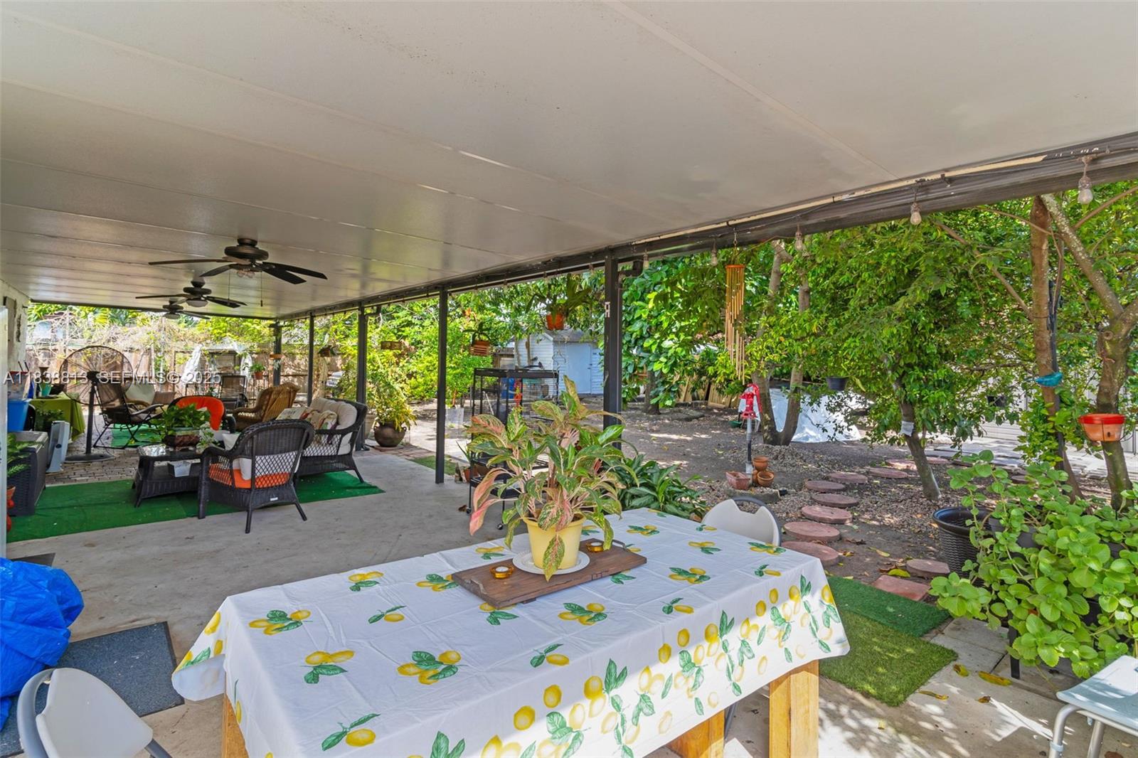 25237 Southwest 133rd Place Homestead, FL 33032 - Photo 33 of 39 a view of an outdoor dining space with a table and chairs