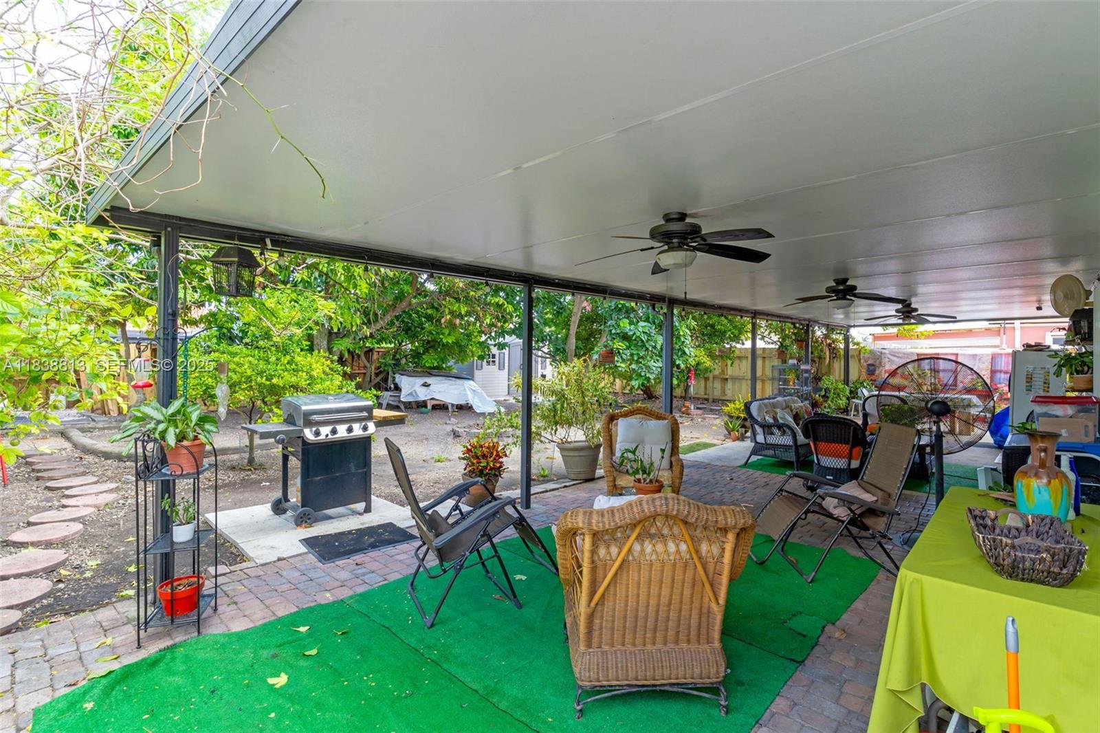 25237 Southwest 133rd Place Homestead, FL 33032 - Photo 34 of 39 a view of a patio with table and chairs under an umbrella