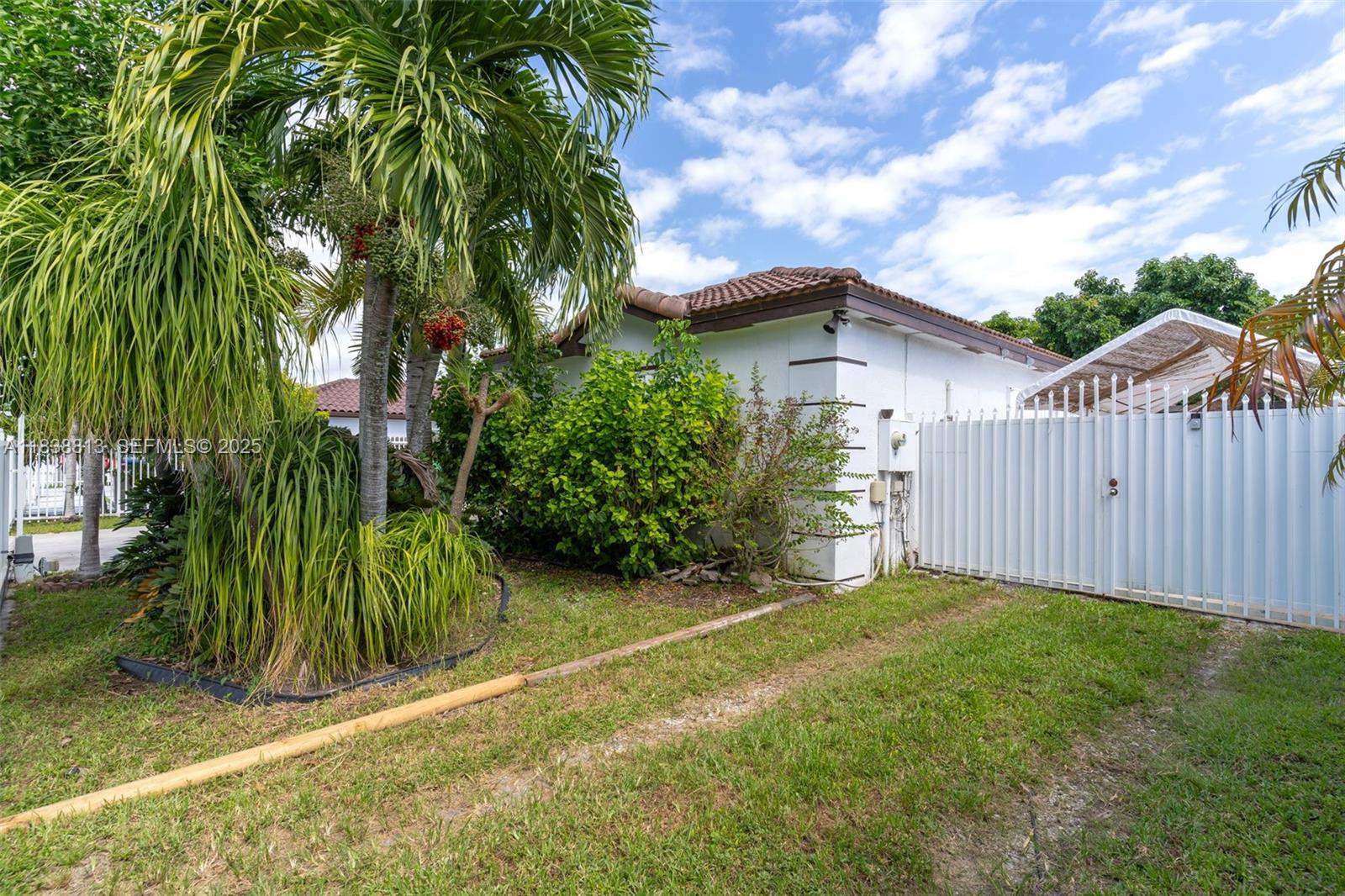 25237 Southwest 133rd Place Homestead, FL 33032 - Photo 5 of 39 a view of a backyard with plants and large trees