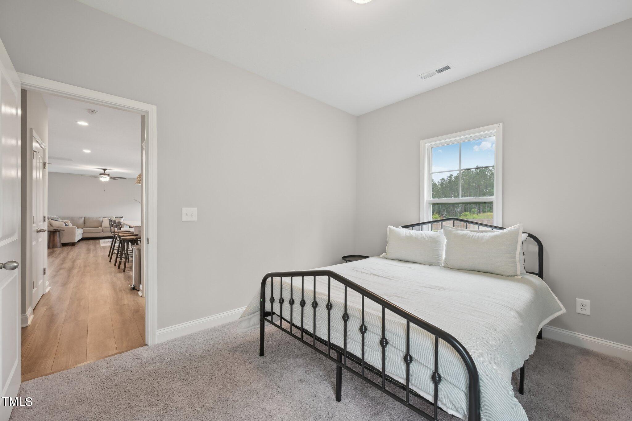 195 Solomon Drive Cameron, NC 28326 - Photo 23 of 46 a bedroom with a bed and a window