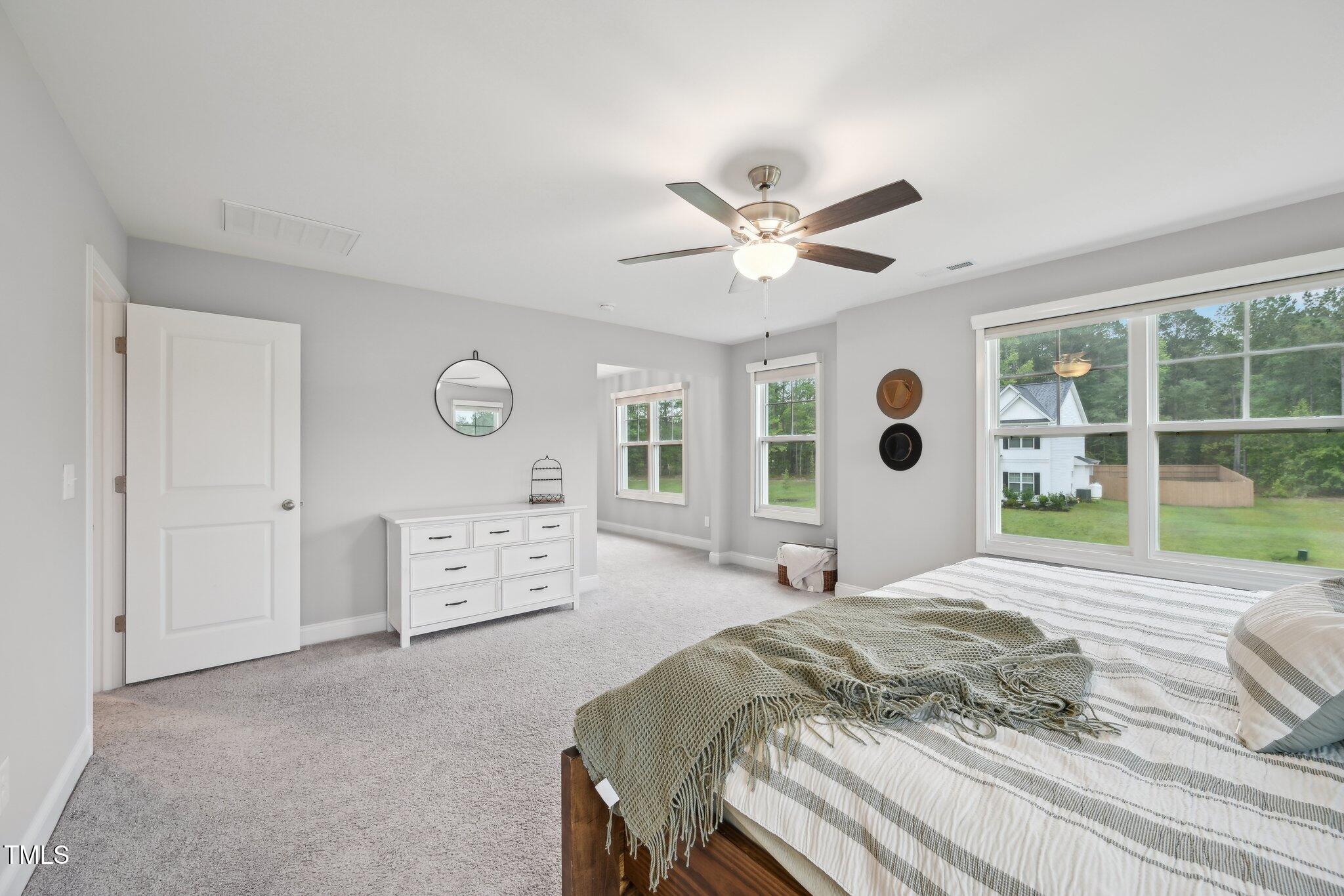 195 Solomon Drive Cameron, NC 28326 - Photo 25 of 46 a spacious bedroom with a large bed and a window