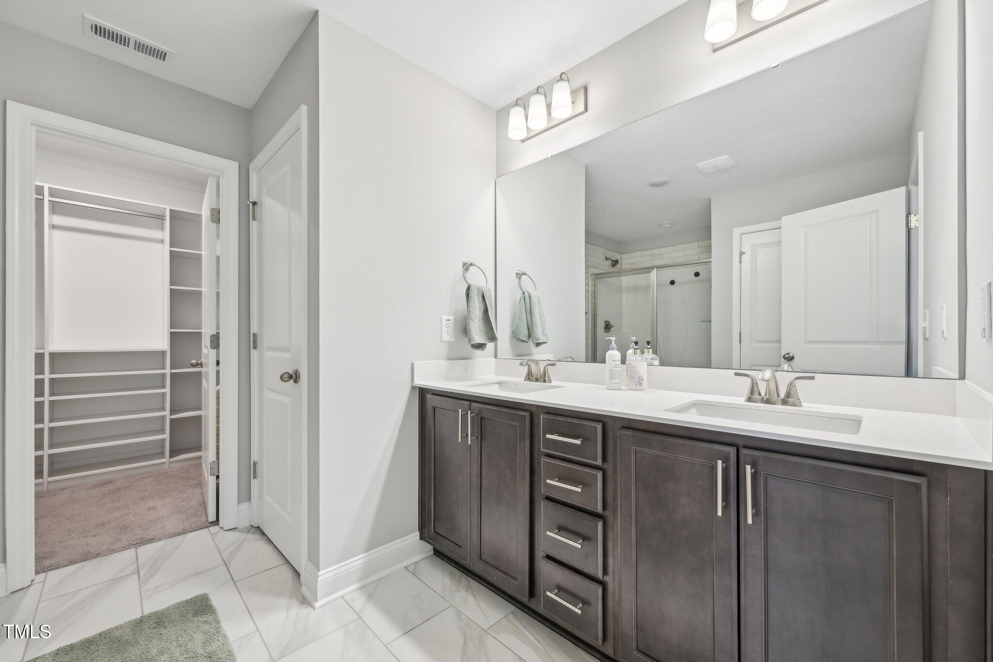195 Solomon Drive Cameron, NC 28326 - Photo 29 of 46 a bathroom with a double vanity sink and mirror