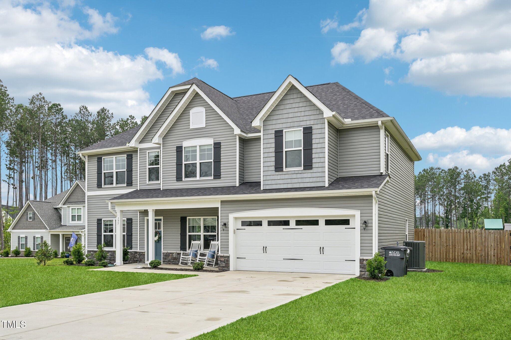 195 Solomon Drive Cameron, NC 28326 - Photo 3 of 46 a view of a yard in front of a brick house with plants and large trees