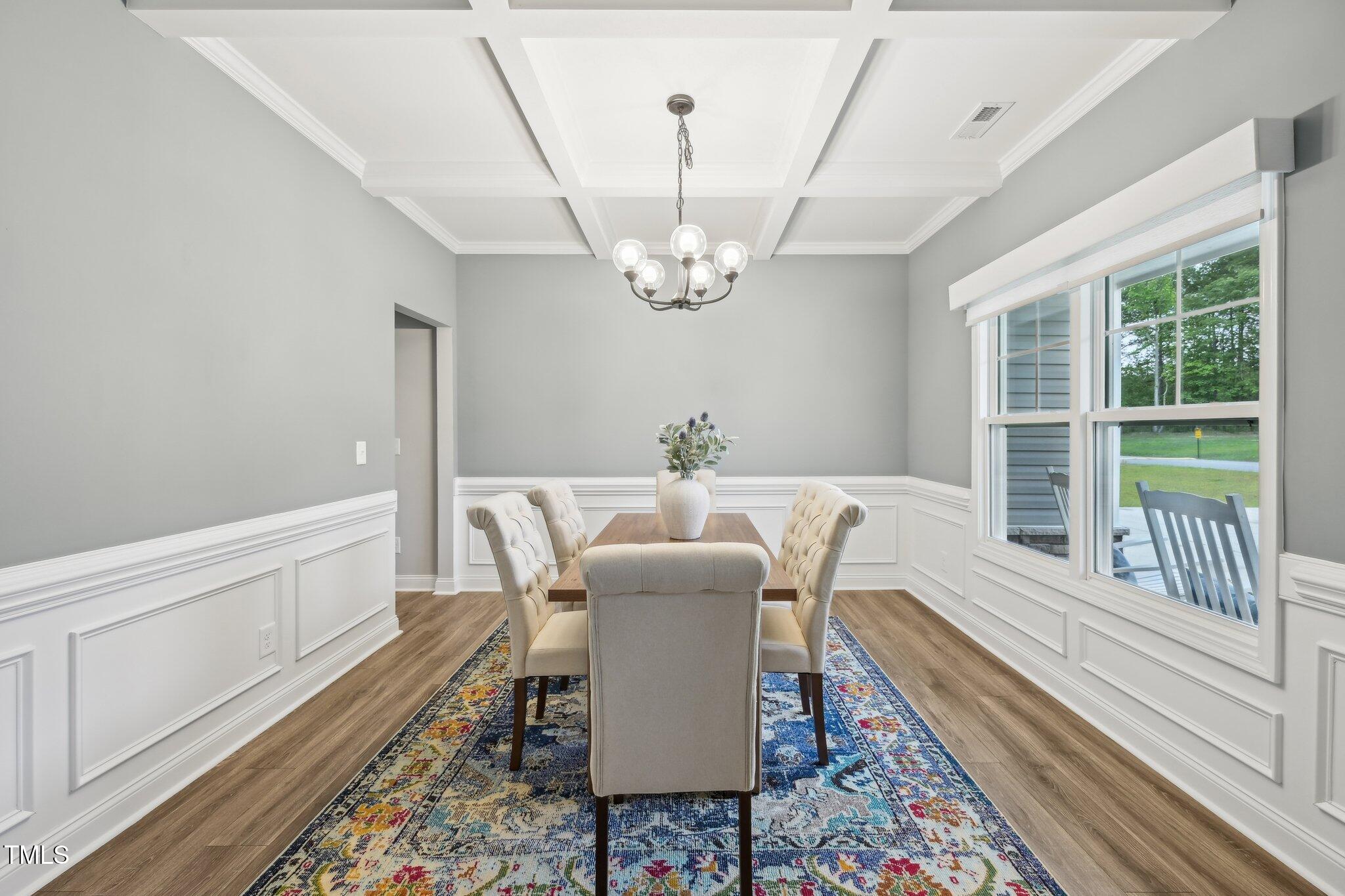 195 Solomon Drive Cameron, NC 28326 - Photo 9 of 46 a dining room with wooden floor a chandelier a wooden table and chairs