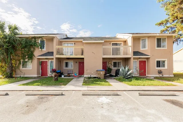 front view of a brick house with a yard