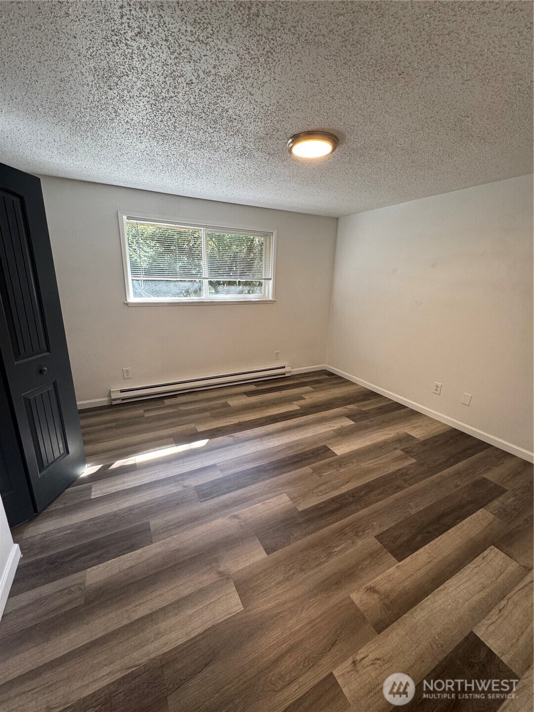5323 Rumac Street Southeast Lacey, WA 98513 - Photo 18 of 23 a view of a room with wooden floor and windows