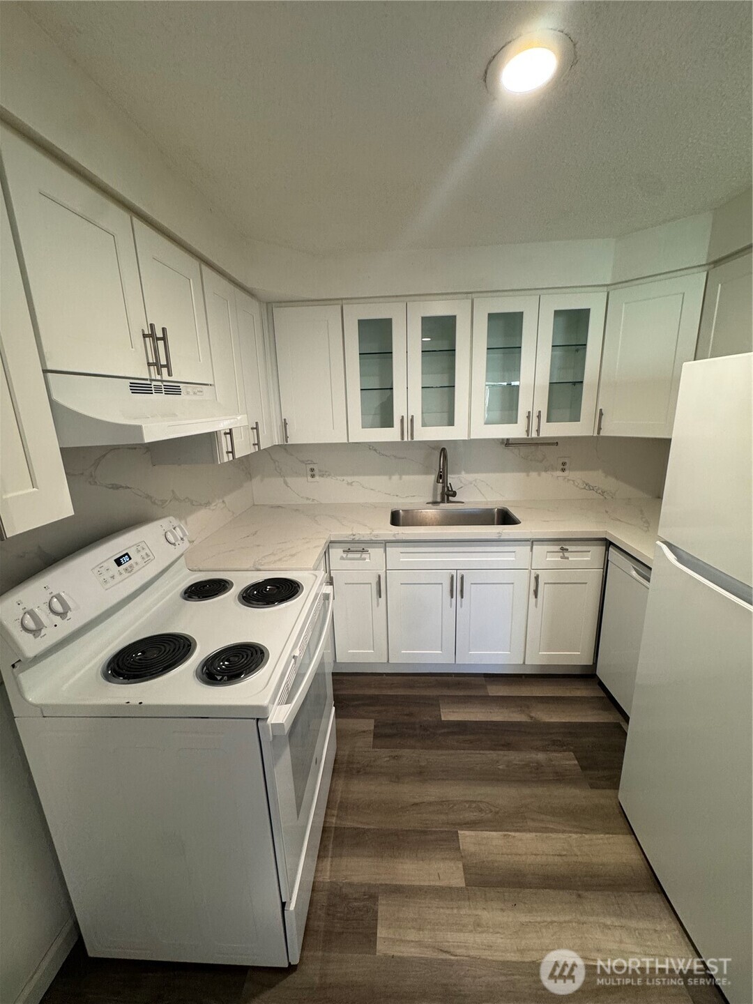 5323 Rumac Street Southeast Lacey, WA 98513 - Photo 7 of 23 a white kitchen with a stove a sink and a refrigerator