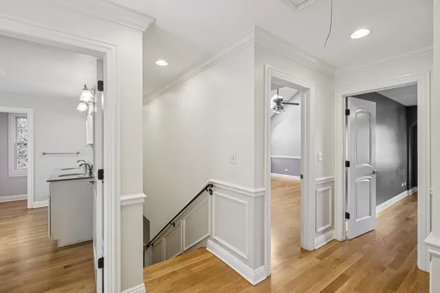 a view of an empty room with a chandelier fan