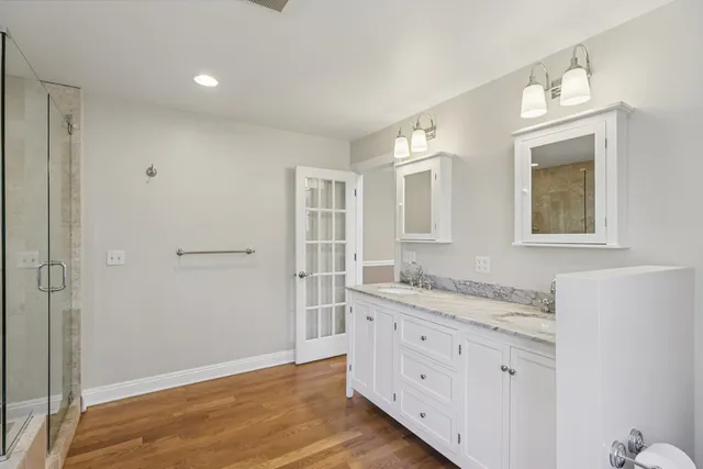 a bathroom with a sink a toilet and shower