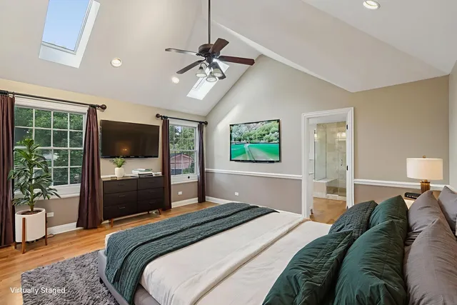 an empty room with wooden floor cabinet and windows