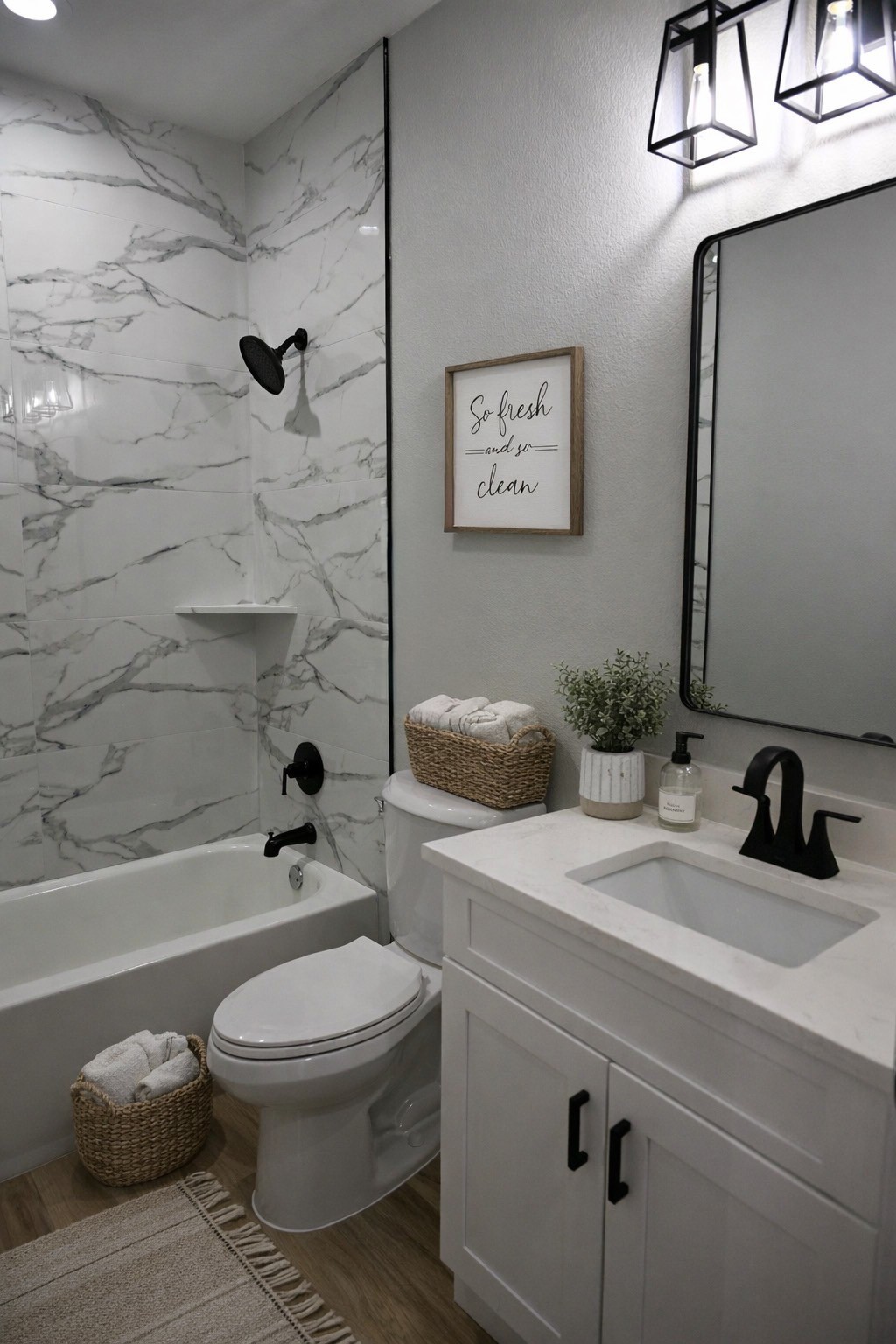 516 North Hackberry Avenue Luling, TX 78648 - Photo 4 of 36 Full bath featuring vanity, a combined bath / shower with marble appearance, and wood finished floors