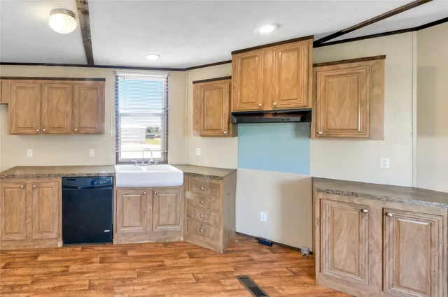 a kitchen with stainless steel appliances granite countertop a refrigerator a sink and a stove