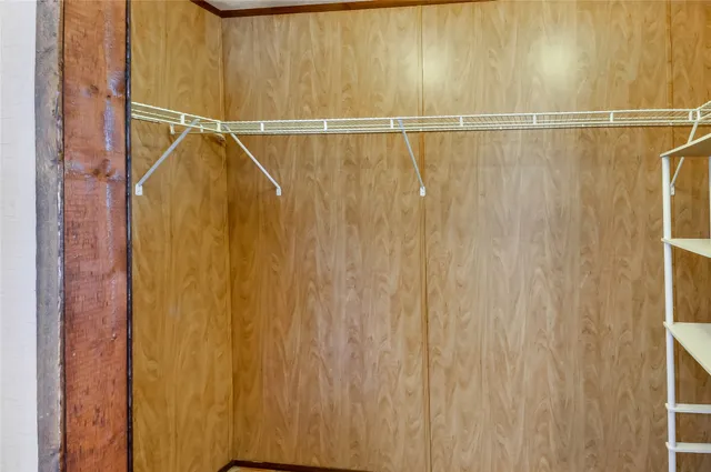 a view of a hallway with furniture and a refrigerator