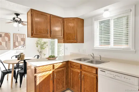 a kitchen with a sink cabinets and window