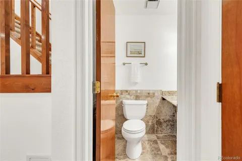 a white toilet sitting next to a bathroom sink
