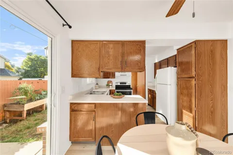 a dining room with furniture a window and wooden floor