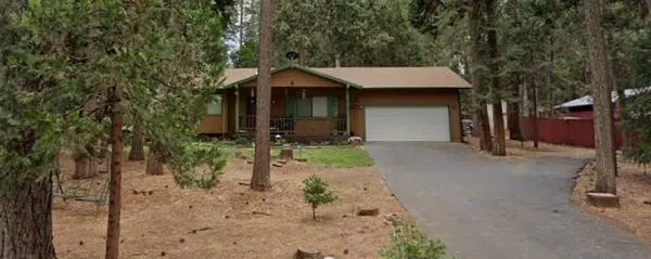 a backyard of a house with barbeque oven table and chairs