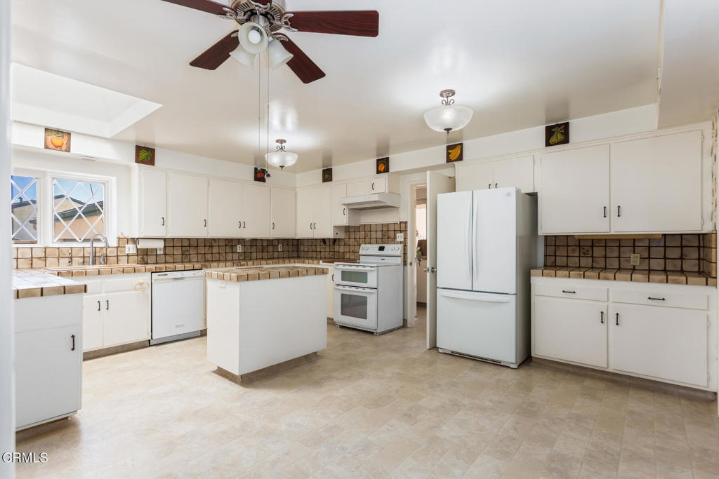 5029 Princess Anne Road La Canada Flintridge, CA 91011 - Photo 8 of 46 a kitchen with white cabinets and white appliances