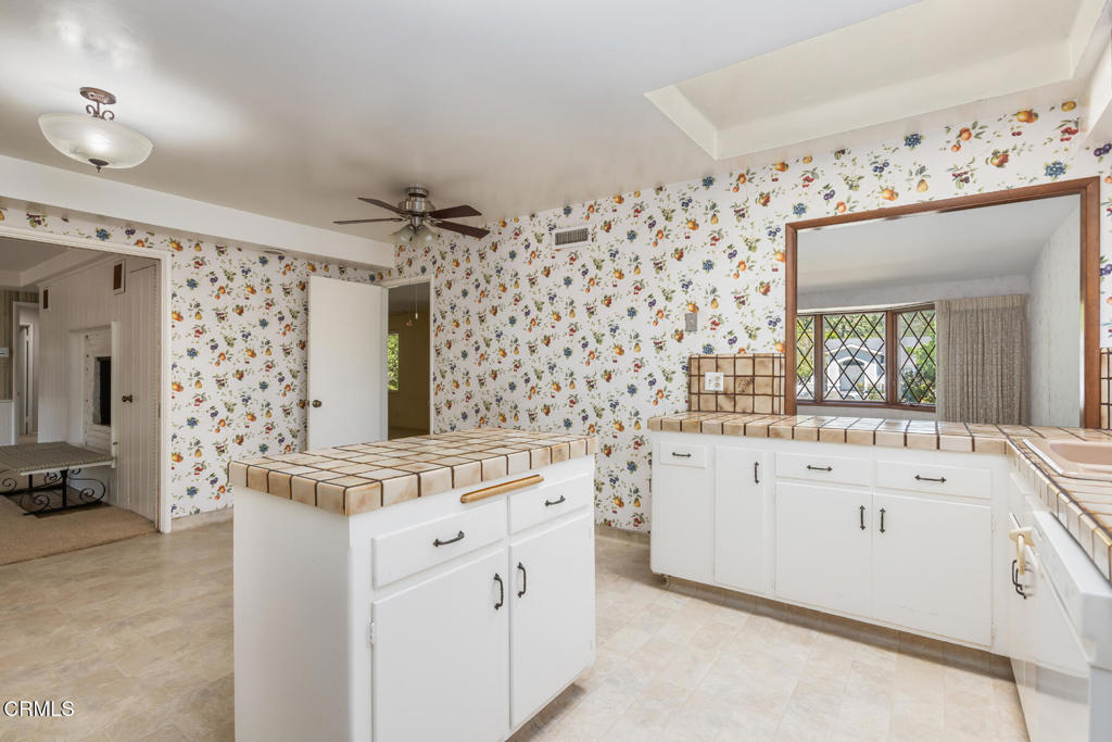 5029 Princess Anne Road La Canada Flintridge, CA 91011 - Photo 10 of 46 a kitchen with granite countertop white cabinets and white appliances