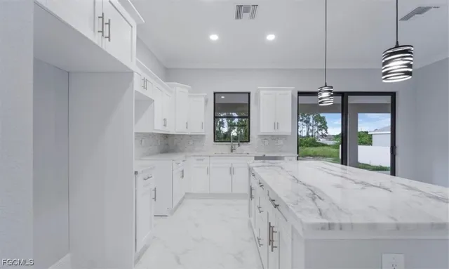 an empty room with a ceiling fan and carpet